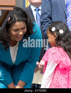 San Francisco, CA - June 26, 2024: Mayor London Breed speaking with a child who came up to the podeium at a Rally about the Safe, Healthy and Vibrant Stock Photo