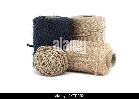 Assorted jute and twine spools on a white background showcasing natural fiber materials for crafting and packaging Stock Photo