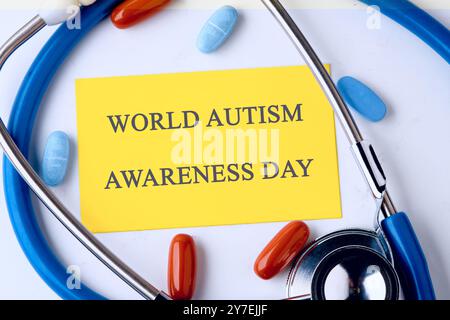 WORLD AUTISM AWARENESS DAY written on the yellow card. Concept photo Stock Photo