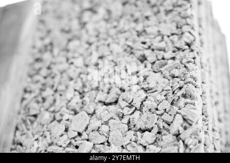 Close up view of building material showing tiny stones held together, providing strength and durability in construction. - black n white - Stock Photo