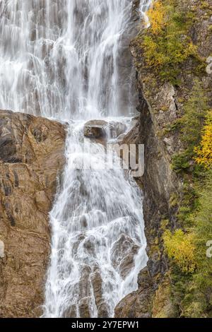 Waterfall on a rock wall with autumn colors Stock Photo
