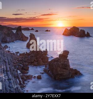 Sunset at the rock formation of Los Urros de Liencres, part of a fabulous Geology Nature Park in Cantabria in northwestern Spain. Stock Photo