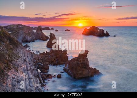 Sunset at the rock formations of Los Urros de Liencres, part of a fabulous Geology Nature Park in Cantabria in northwestern Spain. Stock Photo