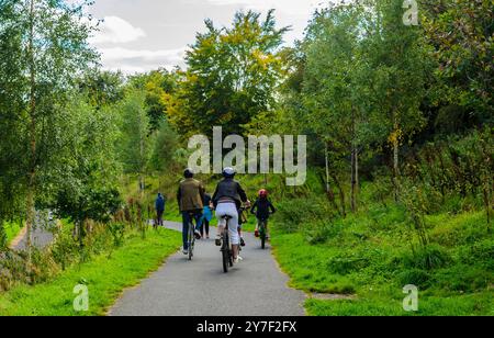 Belfast, County Down, Northern Ireland September 15 2024 - A family on a cycling trip on the towpath beside the River Lagan at Stranmillis, talen from Stock Photo