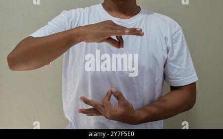 Young man learning and communicating in american sign language Stock Photo