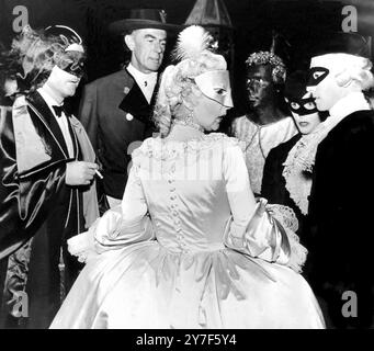 The Great Venetian Party A fabulous house warming party held by Spanish Millionaire, Don Carlos De Bestegui Y Iturbi at his new palace on the Grand Canal, Venice attracted the cream of society from all over Europe.  Pictured: Woolworth heiress, Barbara Hutton in a mask (second from right) with other guests.  5th September 1951 Stock Photo