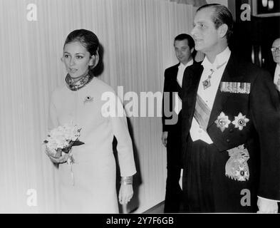 Belgian Princess Paola in a full length evening dress is escorted into the Banqueting House in Whitehall London by Duke of Edinburgh 13th MArch 1968h Stock Photo