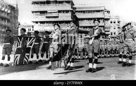 Britain's Last Parade in India - Somerset's Farewell Display - - 4th March 1948 - - The withdrawal of British power from India was completed with the last serving battalion, the 1st Battalion The Somerset Light Infantry, holding a farewell parade when its colours were lowered in salute to India and then marched through the Gateway of India in Bombay, on 28th February. After this the Battalion embarked on the 'Empress of Australia' on their voyage home. - - Photo Shows : The King's and Regimental Colours dipped in salute to India as the Colour Party of the Somerset Light Infantry file into the Stock Photo