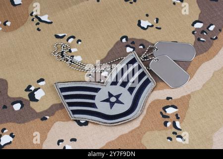 US AIR FORCE Staff Sergeant rank patch and dog tags on desert camouflage uniform Stock Photo