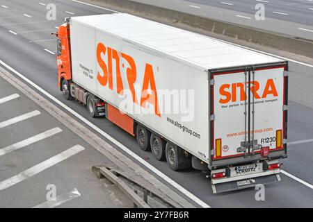 Sitra specialist food transporter business side back rear view semi trailer towed by hgv prime mover lorry truck on M25 motorway road Essex England UK Stock Photo