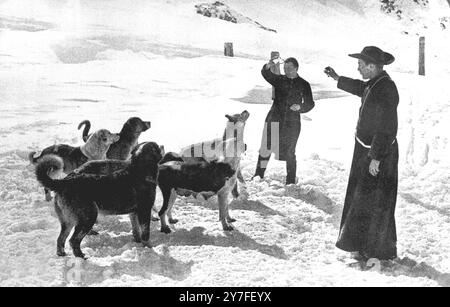 St. Bernard Monks Snowed Up.  The Monks of St. Bernard are isolated in their Hospice, owing to heavy snow which has been falling continuously for the last three days.   Picture shows:- Monks of the Hospice of the Great St. Bernard training their dogs.   December 15  1923 Stock Photo