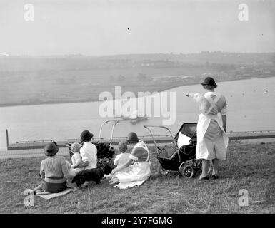 Nannies and their charges on the banks of the Medway at Rochester, 27th September 1937. The flying boat was one of the Empire Class, Cambria. These aircraft flew the luxury overseas routes of Imperial Airways and were the forerunners of the Sutherland Flying Boats. The Short Bros. Aircraft Works were based at this spot from 1913 until in 1947, having suffered heavily from war damage. Stock Photo