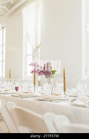 White wedding dinner reception with spring lilacs Stock Photo