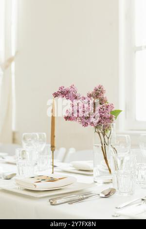 Spring wedding centre piece with purple lilacs Stock Photo
