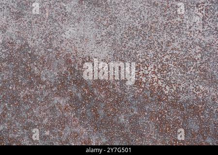 Corroded metal surface. Texture of a heavily rusted metal surface with remnants of white paint, close-up, high resolution. Stock Photo