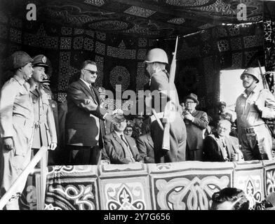 24 DECEMBER 1964 Gamal Abdel Nasser, President of the United Arab Republic, welcomes troops back from their operations in Yemen at the 8th anniversary parade celebrating the withdrawal of Anglo-French troops after the 1956 Suez invasion. Port Said, Egypt. Stock Photo