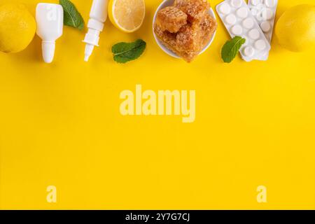 Cold and flu autumn season concept, traditional and alternative cold and flu treatments, pills, drops for runny nose, lemon, honey and mint on bright Stock Photo