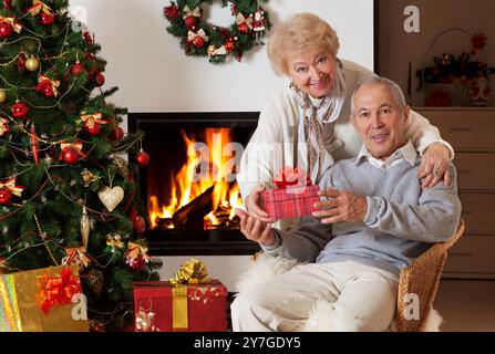 Happy senior man getting Christmas present, smiling Stock Photo