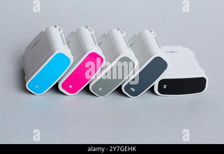 Cartridges color for wide format plotter on grey background. Bright creative concept minimal Stock Photo