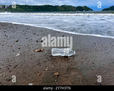 Plastic water bottle discarded along the beach Stock Photo