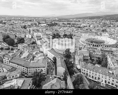 Aerial view of the historic city of Verona, Italy, featuring the famous ancient Roman amphitheater, Arena di Verona, with surrounding buildings. Stock Photo