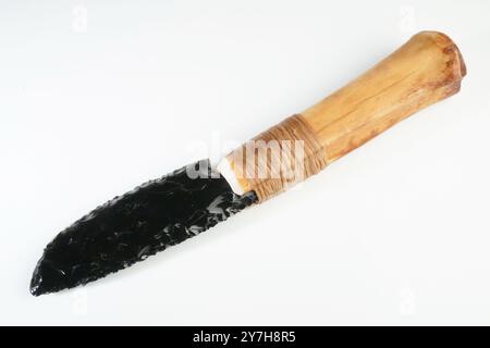 Stone Age Knife with Bone Handle and Obsidian Blade isolated on white Background Stock Photo