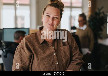 Portrait of smiling businesswoman at workplace Stock Photo