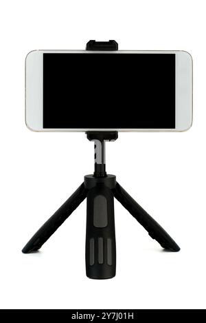 A smartphone mounted on a tripod stand, isolated against a white background. The image highlights mobile photography or videography equipment Stock Photo