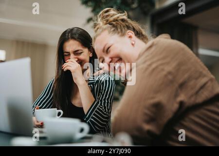 Female colleagues having fun at coffee break in office Stock Photo