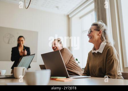 Happy female business professionals discussing at meeting room Stock Photo