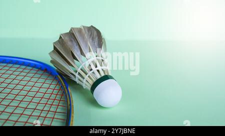 Badminton shuttlecocks with rackets on a green background symbolizing the spirit of exercise and global competition the essence of athleticism and the Stock Photo