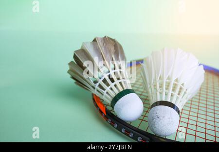 Badminton shuttlecocks with rackets on a green background symbolizing the spirit of exercise and global competition the essence of athleticism and the Stock Photo