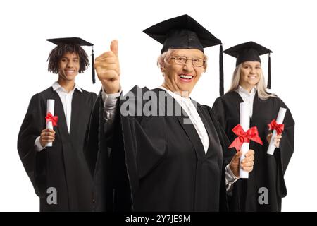 Senior woman with graduate students in gowns isolated on white background Stock Photo