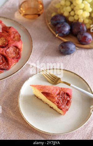 Plum pie upside down on white wooden table Stock Photo