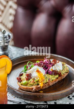 Avocado guacamole toast with poached eggs on top. Brunch food. Stock Photo