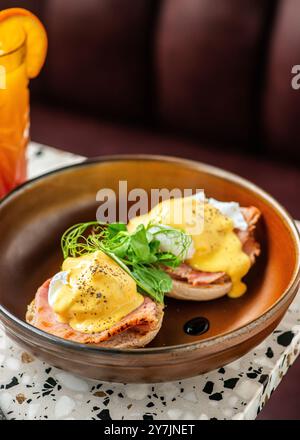 Poached eggs and ham toast with salad on top. Stock Photo