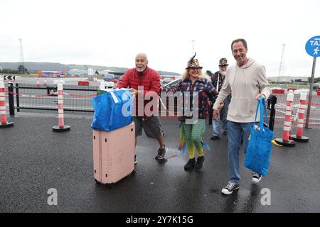 Melody Thor Hennessee (centre) prepares to board the Villa Vie Odyssey cruise ship at Belfast Port's Cruise Ship Terminal, after the luxury cruise ship became marooned in Belfast for four months due to unexpected repair works. Picture date: Monday September 30, 2024. Stock Photo