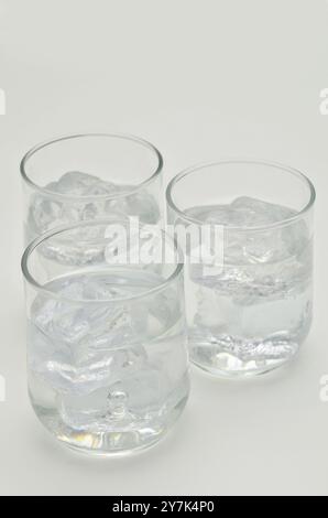 three glasses of water with ice cubes, close up, isolated on white background Stock Photo