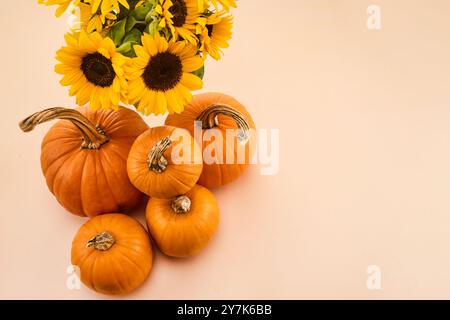 . A cozy autumn scene featuring pumpkins and sunflowers. Stock Photo