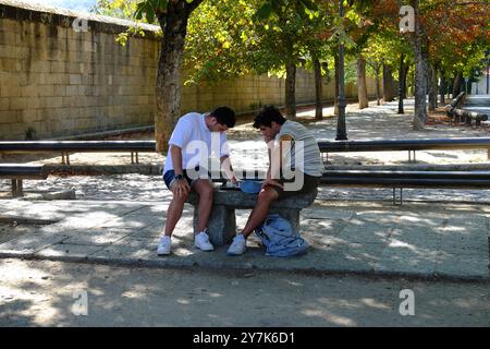 Two men playing chess in the street. San Lorenzo de El Escorial, Madrid. Stock Photo