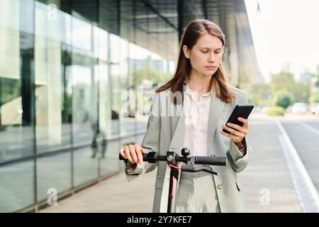 Young Woman Checking Map App On Smartphone Stock Photo
