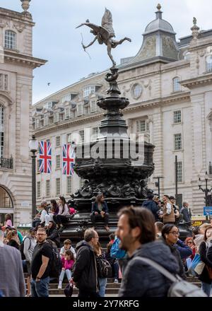 London, England, Apr 30 2023: Statue of Eros in Piccadilly Circus with a crowd around in a very busy day, tourists and locals always walking around. Stock Photo