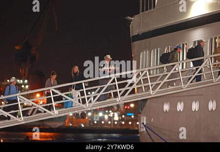 Passengers board the Villa Vie Odyssey cruise ship at Belfast Port's Cruise Ship Terminal, after the luxury cruise ship became marooned in Belfast for four months due to unexpected repair works. Picture date: Monday September 30, 2024. Stock Photo