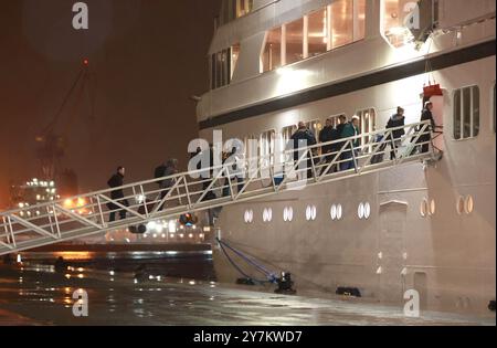 Passengers board the Villa Vie Odyssey cruise ship at Belfast Port's Cruise Ship Terminal, after the luxury cruise ship became marooned in Belfast for four months due to unexpected repair works. Picture date: Monday September 30, 2024. Stock Photo