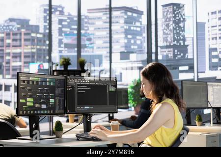 Employee conducting code review to fix bugs, identifying performance and technical issues with machine learning company software. IT specialist debugging and optimizing neural network code Stock Photo