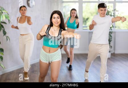 Teenagers practicing breakdance toprock moves in training hall. Teenagers engaged in breakdance Stock Photo