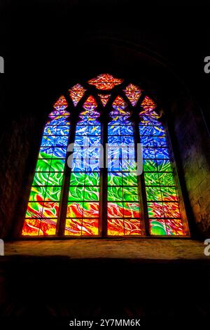 A colourful circular stained-glass window over the side entrance to the