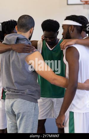 Huddling and strategizing, basketball team bonding before game Stock Photo