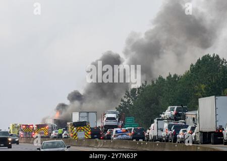 Firefighters respond to a fire on US 295, east of Richmond. A fire shutdown traffic during morning rush hour east of Richmond, VA on Monday morning. At approximately 8:15 a.m. Virginia State Police responded to northbound Interstate 295 on the Varina-Enon Bridge for a tractor-trailer that caught fire. After initial investigation, it was found that the truck struck the bridge on the right hand side before catching fire. It was hauling paper products, The driver was not injured and charges remain pending. This crash remains under investigation.' Stock Photo