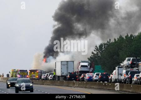 Firefighters respond to a fire on US 295, east of Richmond. A fire shutdown traffic during morning rush hour east of Richmond, VA on Monday morning. At approximately 8:15 a.m. Virginia State Police responded to northbound Interstate 295 on the Varina-Enon Bridge for a tractor-trailer that caught fire. After initial investigation, it was found that the truck struck the bridge on the right hand side before catching fire. It was hauling paper products, The driver was not injured and charges remain pending. This crash remains under investigation.' Stock Photo